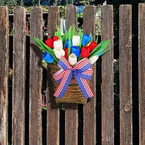 Patriotic red white and blue tulip wall hanging decor with American flag bow on fence