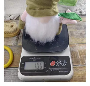 Plush Easter faceless gnome decoration being weighed on a kitchen scale