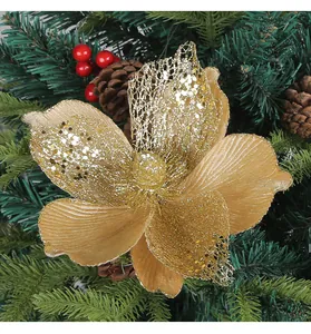 Macro detail of a golden glitter Christmas flower on a pine tree branch