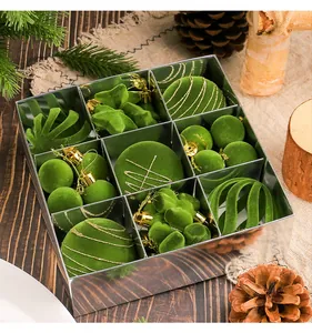 Close-up of a 35pcs green flocked Christmas ornament gift set in a silver box