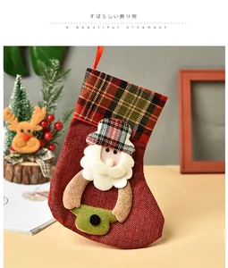 Detailed shot of a red plaid Christmas stocking with Santa Claus applique ornament