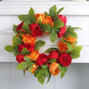 Vibrant red and orange artificial peony flower wreath for home and wedding decor