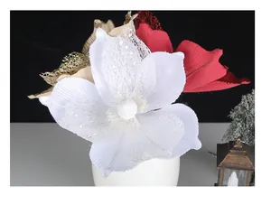 Close-up detail of white and red glitter artificial Christmas flowers with mesh texture
