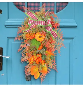 Autumn Thanksgiving door wreath featuring pumpkins and a red plaid bow decoration