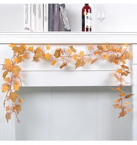 Detailed view of the orange autumn sweet potato leaf garland on a white fireplace mantel.