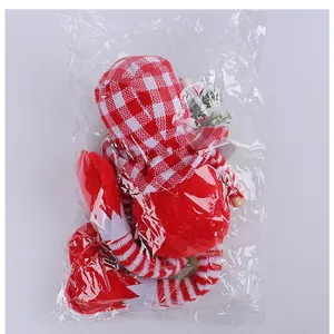 Macro view of Christmas gnome in plastic packaging showing checkered hat and striped legs