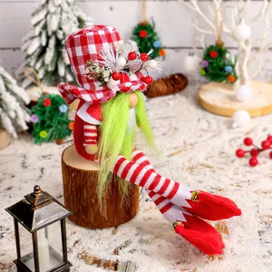 Festive Christmas gnome plush with green beard and red checkered hat on a wooden stump.