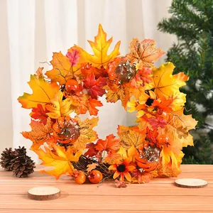 Beautiful autumn harvest wreath with maple leaves and mini pumpkins for home door decor