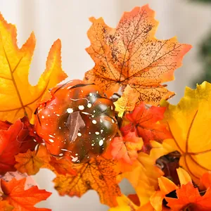 Autumn harvest wreath featuring orange pumpkins and vibrant maple leaves for door decor