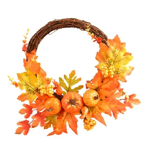 Autumn harvest wreath featuring orange pumpkins and maple leaves for Halloween door decor