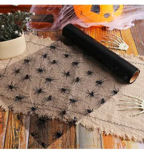 Close-up of black Halloween mesh roll with spider patterns for table decoration