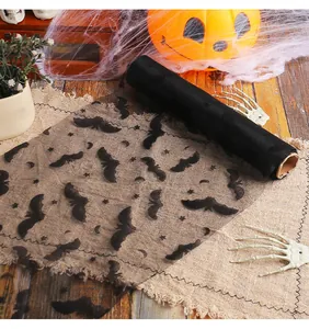 Detailed view of Halloween black mesh fabric roll with bat prints for table decoration