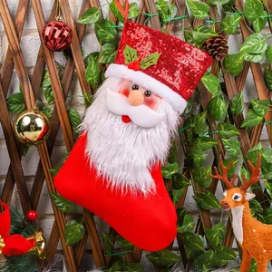 Festive Santa Christmas stocking with red sequins and plush beard for holiday gift bag