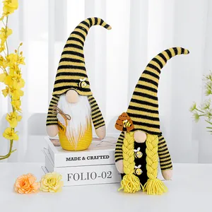 Pair of cute bee festival faceless gnomes with yellow and black striped hats