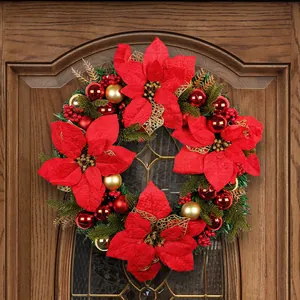 Festive large Christmas wreath with red poinsettia and gold ornaments on a door