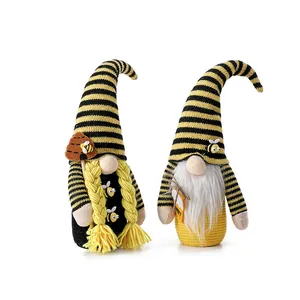 Handmade bee festival gnome dolls with yellow-black striped hats and honey tags.