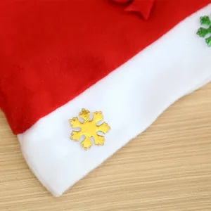 Close-up of a red brushed fabric Christmas hat with a golden snowflake decoration