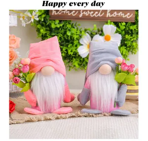 Close-up of pink and grey Valentine's Day gnomes holding tulip bouquets for home decor.