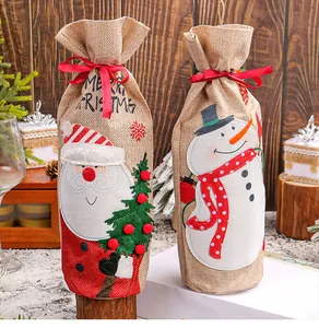Set of two festive Christmas burlap wine bottle bags featuring Santa and Snowman designs