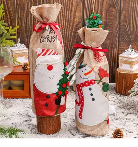 Set of two festive burlap wine bottle bags with Santa and Snowman designs for Christmas