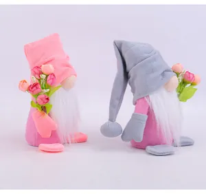 Pair of plush Valentine gnomes holding colorful tulip bouquets on a clean white background