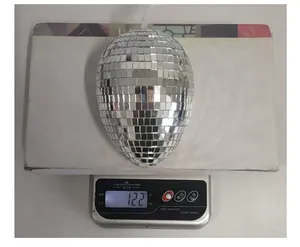 Weight measurement of egg-shaped disco ball Easter ornament shown on a scale at 122g.