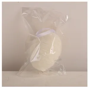 Detail view of a white woven Easter egg hanging ornament in clear plastic packaging