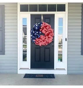 American flag mesh wreath hanging on a front door for Independence Day decor