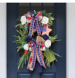 Detailed view of Independence Day wreath with patriotic ribbons and roses on a blue door