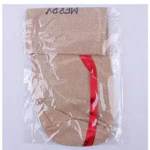 Burlap Christmas wine bottle bag featuring a red ribbon and printed Merry text detail