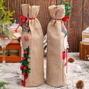 Festive burlap Christmas wine bottle covers with Santa and snowman designs for holiday tables