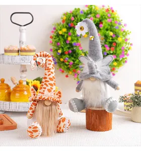 Close-up detail of cute giraffe and elephant themed plush gnomes for festive home decoration