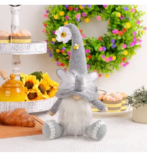 Detailed view of a cute grey sitting gnome plush doll with a flower and bee decoration