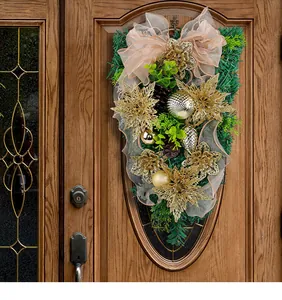 Close-up of elegant gold poinsettias and greenery on this Christmas teardrop swag decor.