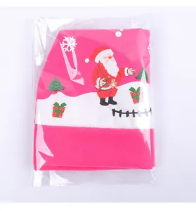 Detailed view of festive pink Christmas car seat cover featuring Santa pattern in packaging