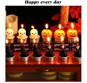 Detail view of lit Halloween candles shaped as pumpkins, skulls, cats, and witches