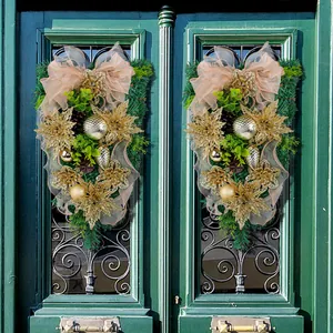 Festive gold Christmas flower pine needle swag with an elegant peach bow for doors.