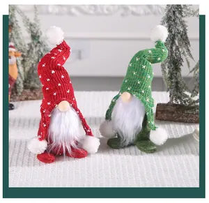 Detailed view of red and green knitted Christmas gnomes with fluffy white beards