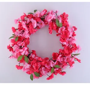 Detailed macro shot of a vibrant pink artificial cherry blossom wreath for spring door decor