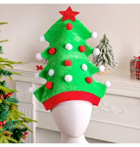 Detailed view of a green Christmas tree hat with red pom-poms on a white mannequin head.