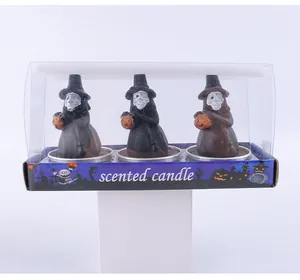 Halloween witch-shaped scented candle set featuring pumpkin accents in a clear 3-pack box.