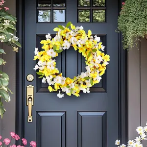 Spring floral wreath with yellow and white blossoms for front door and wall decoration