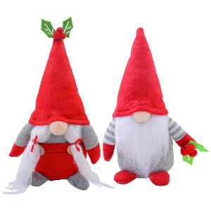Pair of festive Christmas gnome plush dolls with red tall hats and holly berry accents.