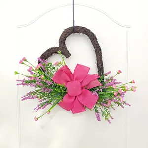 Handmade heart-shaped floral wreath with pink bow and lavender for door decoration