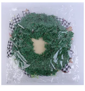Artificial Christmas wreath with black and white buffalo plaid ribbons in a clear plastic bag