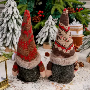 Paire de gnomes de Noël avec bonnets tricotés flocons dans un décor de neige festif