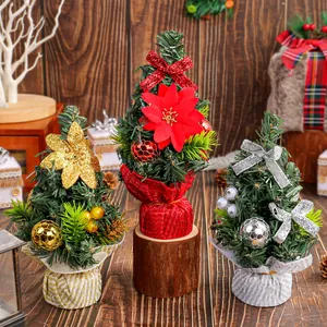 Set of three mini tabletop Christmas trees with festive bows and floral ornaments