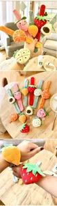 Close-up of children's plush slap bracelets featuring cute cartoon fruit designs.