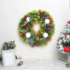 Artificial autumn eucalyptus wreath with white pumpkins and berries for home decoration