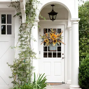 Autumn harvest door basket with sunflowers and pinecones on a white porch door